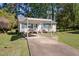 Exterior view of a single-story home with a carport and a well-kept lawn at 105 E Murray Ave, Durham, NC 27704