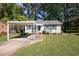 Charming single-story home features a carport, blue shutters, and a well-maintained front lawn at 105 E Murray Ave, Durham, NC 27704