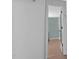 View of a hallway with an open bedroom door. The bedroom has wood laminate flooring at 105 E Murray Ave, Durham, NC 27704
