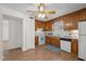 Functional kitchen featuring wood cabinets, white appliances, and hardwood floors at 105 E Murray Ave, Durham, NC 27704
