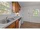Efficient kitchen with a stainless sink, wood cabinets, and views of the backyard at 105 E Murray Ave, Durham, NC 27704