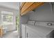 Handy laundry area with side-by-side washer and dryer, and a window in the bathroom at 105 E Murray Ave, Durham, NC 27704