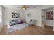 Cozy living room features hardwood floors, a stylish gray sofa, and a ceiling fan at 105 E Murray Ave, Durham, NC 27704