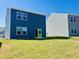 Backyard featuring lawn and exterior of two-story home with slider door at 107 Gabriel Ct, Wilson's Mills, NC 27520