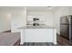 Bright kitchen featuring white cabinetry, stainless steel appliances, and a large island with seating at 107 Gabriel Ct, Wilson's Mills, NC 27520