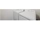 A compact laundry area featuring a white washer and dryer set at 107 Gabriel Ct, Wilson's Mills, NC 27520