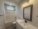 Bathroom with a modern vanity, clean lines, and a tub-shower combo at 107 Tee Dr, Selma, NC 27576