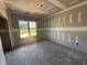 Bedroom featuring a large window, unfinished walls, and ceiling details, offering customization potential at 107 Tee Dr, Selma, NC 27576