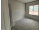 An open bedroom features neutral walls and a large window for natural light at 107 Tee Dr, Selma, NC 27576