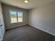 Well-lit bedroom with a large window and plush neutral carpeting, creating a serene atmosphere at 107 Tee Dr, Selma, NC 27576