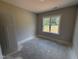 Compact bedroom with a bright window overlooking a sunny landscape at 107 Tee Dr, Selma, NC 27576