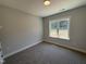 A carpeted bedroom with a well-lit window, offering a comfortable and inviting space at 107 Tee Dr, Selma, NC 27576
