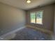 Bedroom featuring a neutral wall color, large windows, and electrical outlets at 107 Tee Dr, Selma, NC 27576