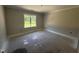 A light-filled bedroom with a large window offering a view of the outdoors at 107 Tee Dr, Selma, NC 27576