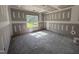 Light-filled bedroom showcasing an unfinished space with a large window and contemporary design elements at 107 Tee Dr, Selma, NC 27576