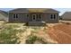 New construction home with gray siding, white trim, and a covered porch at 107 Tee Dr, Selma, NC 27576