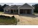 Charming single-story home with a two-car garage, covered porch, and neutral color palette, in a beautiful neighborhood at 107 Tee Dr, Selma, NC 27576
