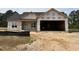 New construction exterior showing the facade and a large two car garage on a sunny day at 107 Tee Dr, Selma, NC 27576