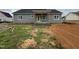 New construction featuring gray siding, a covered porch, and a yard ready for landscaping at 107 Tee Dr, Selma, NC 27576