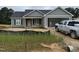 Charming single-story home featuring a gray siding and a welcoming covered porch at 107 Tee Dr, Selma, NC 27576