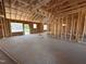 Interior framing shows the layout of the home with studs and a concrete floor at 107 Tee Dr, Selma, NC 27576