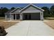 New home exterior showing large garage door and freshly poured driveway at 107 Tee Dr, Selma, NC 27576