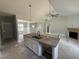 Kitchen island with granite countertop, sink, and open living space at 107 Tee Dr, Selma, NC 27576