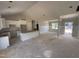Bright, white eat-in kitchen with a central island and unfinished floors at 107 Tee Dr, Selma, NC 27576