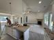 Open-concept kitchen and living area with modern appliances and a spacious island at 107 Tee Dr, Selma, NC 27576
