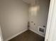 Functional laundry room with tile flooring and utility connections at 107 Tee Dr, Selma, NC 27576