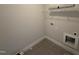 Utility room featuring tile floors, wire shelving, and hookups for laundry machines at 107 Tee Dr, Selma, NC 27576
