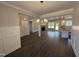 Bright living room featuring modern lighting fixtures, fireplace, and seamless open-concept design to the kitchen at 107 Tee Dr, Selma, NC 27576