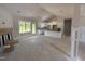 Open-concept living space with fireplace, adjacent to bright, white kitchen at 107 Tee Dr, Selma, NC 27576