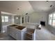 Spacious living room with fireplace and open kitchen with island, creating an inviting atmosphere at 107 Tee Dr, Selma, NC 27576