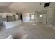 Open concept living room with white wall paneling, and kitchen with white cabinets at 107 Tee Dr, Selma, NC 27576