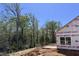 New home construction with a wooded backdrop, showcasing the natural beauty of the homesite at 1075 Fairhaven Dr # 51, Mebane, NC 27302