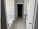 Bathroom showcasing a soaking tub and tile floors with access to a walk-in closet at 1075 Fairhaven Dr # 51, Mebane, NC 27302