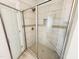 Bathroom featuring a tiled shower with glass door and brushed nickel shower head at 1075 Fairhaven Dr # 51, Mebane, NC 27302