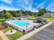 An aerial view of the community pool featuring lounge chairs and a covered picnic area perfect for outdoor gatherings at 1075 Fairhaven Dr # 51, Mebane, NC 27302