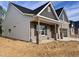 Craftsman-style home with brick accents, vinyl siding, covered porch, and attached two-car garage at 1075 Fairhaven Dr # 51, Mebane, NC 27302