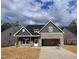 Charming single-Gathering home with brick and gray siding, two-car garage, and welcoming curb appeal at 1075 Fairhaven Dr # 51, Mebane, NC 27302