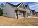 Craftsman-style home with brick accents, vinyl siding, covered porch, and attached two-car garage at 1075 Fairhaven Dr # 51, Mebane, NC 27302