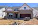 New brick home under construction, featuring a gable roof and a two-car garage at 1075 Fairhaven Dr # 51, Mebane, NC 27302