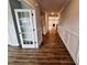 Hallway with hardwood floors leading into an open space with a fireplace, offers a seamless flow at 1075 Fairhaven Dr # 51, Mebane, NC 27302
