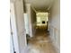 Hallway leading to a living room with fireplace and large windows providing abundant natural light at 1075 Fairhaven Dr # 51, Mebane, NC 27302