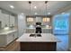 Well-lit kitchen with a center island, pendant lighting, stainless steel appliances, and ample counter space at 1075 Fairhaven Dr # 51, Mebane, NC 27302