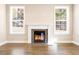 Bright living room featuring a modern fireplace, mantle and large windows at 1075 Fairhaven Dr # 51, Mebane, NC 27302