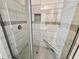 Modern tiled shower with glass door and built-in seat, offering a luxurious bathing experience at 1075 Fairhaven Dr # 51, Mebane, NC 27302