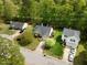 Aerial view of the home, landscaped yard and mature trees at 108 Braxberry Way, Holly Springs, NC 27540