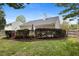 Exterior view featuring a deck with stairs and trimmed hedges at 108 Braxberry Way, Holly Springs, NC 27540